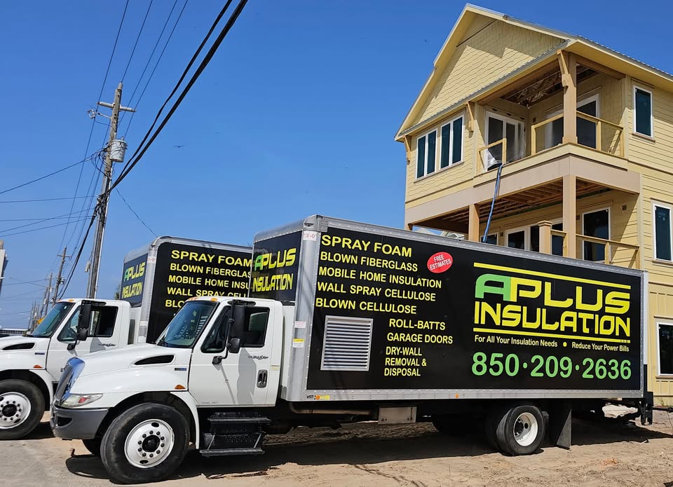 A Plus Insulation service trucks parked in front of a home